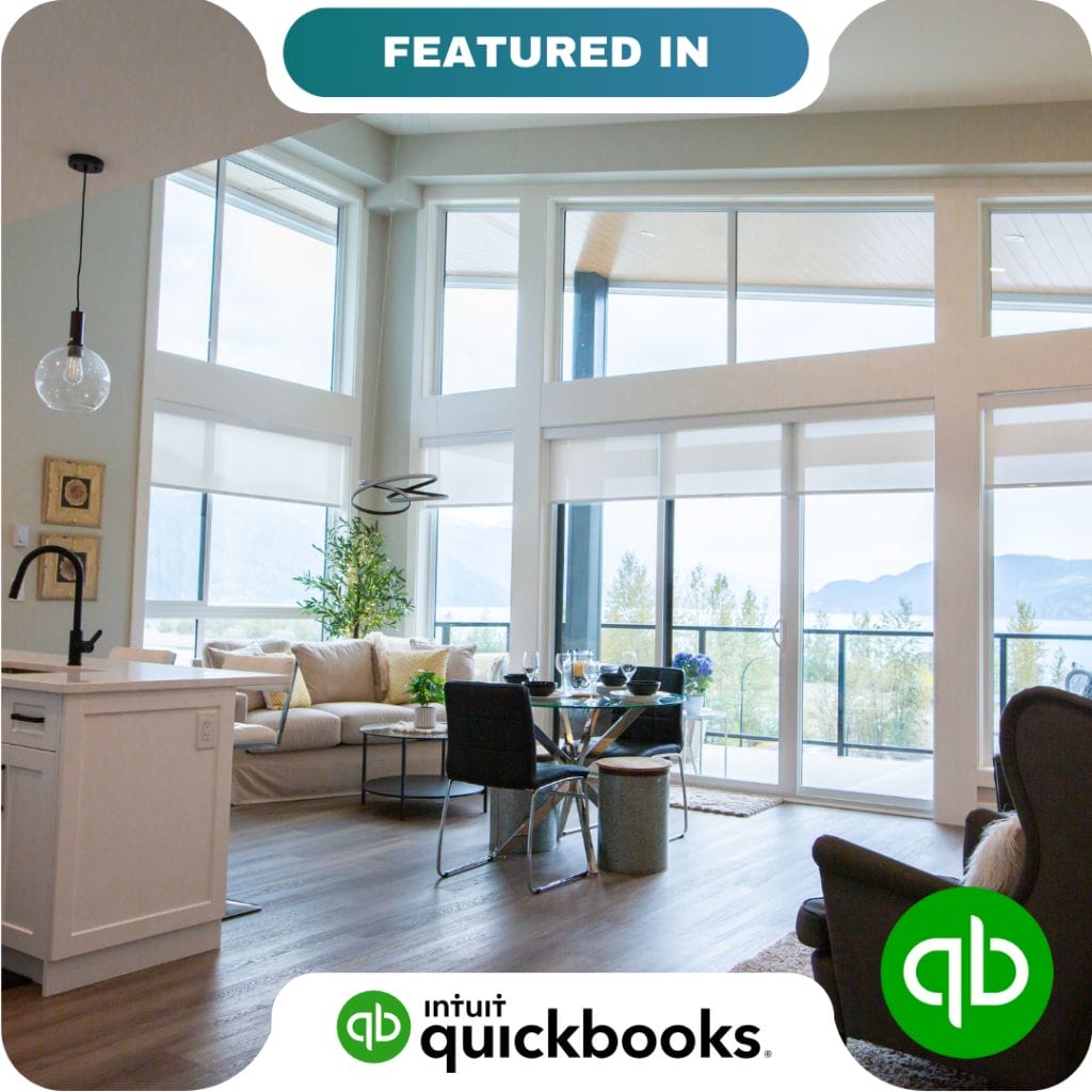 Modern living room with large windows, a sofa, dining table, and kitchen area; QuickBooks logos and "Featured In" text overlay highlight trusted partners.