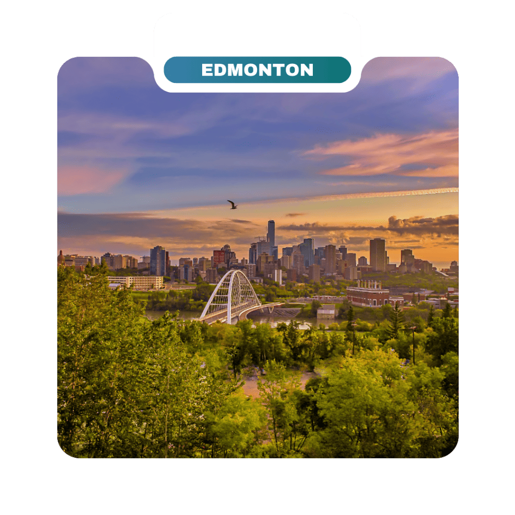Edmonton city skyline at sunset with a white bridge, tall buildings, and green trees in the foreground invites homeowners and travelers alike to explore one of Canada’s most captivating destinations. A bird soars gracefully in the sky overhead.