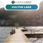 A wooden dock extends into Cultus Grove’s shimmering lake, with people relaxing on it; houses and trees line the sunny opposite shore. Text reads "Cultus Grove" and "Cultus Lake.